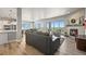 Bright open-concept living room with modern decor, fireplace, and access to outdoor views at 3293 Offbeaten Pl, Castle Rock, CO 80108