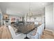 Bright open-concept living space showcasing stylish dining area, modern kitchen, and cozy fireplace at 3293 Offbeaten Pl, Castle Rock, CO 80108