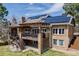 Back exterior showcases a deck and solar panels, blending sustainability with outdoor living at 2162 Terraridge Dr, Highlands Ranch, CO 80126