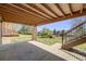Covered patio offers a shaded retreat with views of the lush backyard and landscaped garden at 2162 Terraridge Dr, Highlands Ranch, CO 80126