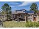 Spacious two-story home with solar panels, a deck, and a large, green backyard with mature trees at 2162 Terraridge Dr, Highlands Ranch, CO 80126