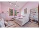 Bright bedroom with pink walls, white furniture, and a comfortable reading nook at 2162 Terraridge Dr, Highlands Ranch, CO 80126