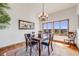 Formal dining room featuring high ceilings, hardwood floors, and beautiful views of the surrounding landscape at 2162 Terraridge Dr, Highlands Ranch, CO 80126