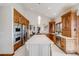 Spacious kitchen with a center island, custom wood cabinetry, stainless steel appliances, and modern countertops at 2162 Terraridge Dr, Highlands Ranch, CO 80126