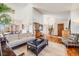 Bright and airy living room featuring a cozy seating arrangement and direct access to dining area at 2162 Terraridge Dr, Highlands Ranch, CO 80126