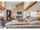 Spacious living room features a brick fireplace, high ceilings, and comfortable leather furniture at 2162 Terraridge Dr, Highlands Ranch, CO 80126