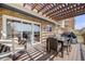 Relaxing outdoor deck featuring comfortable seating, dining area, and pergola at 2162 Terraridge Dr, Highlands Ranch, CO 80126