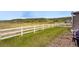 Expansive backyard with a white fence, grill, and lush green grass at 2511 Loon Ln, Castle Rock, CO 80104