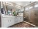 Bright bathroom showcasing double sinks, a large mirror, and a glass-enclosed shower with a bench at 2511 Loon Ln, Castle Rock, CO 80104
