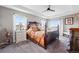 Spacious bedroom featuring a decorative ceiling fan, multiple windows with views, and a luxurious bed at 2511 Loon Ln, Castle Rock, CO 80104