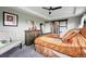 Bedroom featuring unique decor, a decorative ceiling fan, and a view to the closet and entry at 2511 Loon Ln, Castle Rock, CO 80104