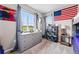 Bedroom with a large window, grey dresser, and playful decor at 2511 Loon Ln, Castle Rock, CO 80104