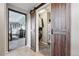 Hallway view of bedroom through open closet featuring a sliding barn door at 2511 Loon Ln, Castle Rock, CO 80104