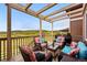 Outdoor deck with wicker furniture set, grill, and beautiful natural views in the background at 2511 Loon Ln, Castle Rock, CO 80104