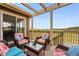 Relaxing outdoor deck with wicker furniture, a glass coffee table, and serene views at 2511 Loon Ln, Castle Rock, CO 80104