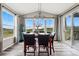 Bright dining room with scenic views from large windows and access to outdoor living area at 2511 Loon Ln, Castle Rock, CO 80104