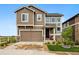 Two-story home with a two-car garage, neutral siding, and a well-maintained front yard with green grass at 2511 Loon Ln, Castle Rock, CO 80104