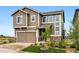 Charming home featuring neutral siding, stone accents, and an attached two car garage, complemented by a lawn at 2511 Loon Ln, Castle Rock, CO 80104