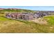 A row of lovely homes sit on a grassy field with scenic mountain views and white picket fences at 2511 Loon Ln, Castle Rock, CO 80104