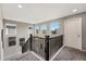 Well-lit upstairs hallway showcasing modern railing and views from multiple windows, carpeted floor at 2511 Loon Ln, Castle Rock, CO 80104