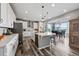 Spacious kitchen featuring white cabinets, modern appliances, a kitchen island and an adjacent dining area at 2511 Loon Ln, Castle Rock, CO 80104
