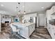 Open-concept kitchen features a large island with seating, white cabinets and stainless steel appliances at 2511 Loon Ln, Castle Rock, CO 80104
