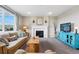 Comfortable living room featuring a fireplace, neutral walls, a large window, and stylish decor at 2511 Loon Ln, Castle Rock, CO 80104
