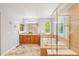Bright bathroom boasts a separate soaking tub and dual sink vanity at 17020 E 107Th Ave, Commerce City, CO 80022