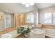 Bright bathroom boasts a separate soaking tub, shower, and dual sink vanity at 17020 E 107Th Ave, Commerce City, CO 80022