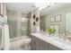 Bright bathroom features a dual sink vanity and a shower over tub at 17020 E 107Th Ave, Commerce City, CO 80022