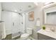 Bathroom featuring a glass shower, modern fixtures, and a gray vanity with a light countertop at 17020 E 107Th Ave, Commerce City, CO 80022