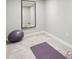 Minimalist fitness room with gray carpet, a large mirror, and exercise equipment at 17020 E 107Th Ave, Commerce City, CO 80022