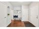 Inviting hallway with hardwood floors, a bench with pillows, a niche with a plant, and neutral paint at 17020 E 107Th Ave, Commerce City, CO 80022