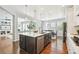 Spacious kitchen featuring a large island with seating, stainless steel appliances, and hardwood floors at 17020 E 107Th Ave, Commerce City, CO 80022