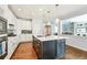 Modern kitchen featuring stainless steel appliances, a large island with seating, and open access to other living areas at 17020 E 107Th Ave, Commerce City, CO 80022