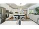 Bright kitchen featuring stainless steel appliances, a spacious island with pendant lighting, and an adjacent dining area at 17020 E 107Th Ave, Commerce City, CO 80022