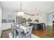 Well-appointed kitchen featuring stainless steel appliances, a center island, modern pendant lighting, and an adjacent dining area at 17020 E 107Th Ave, Commerce City, CO 80022
