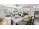 Spacious living room flowing into the kitchen and dining areas, showcasing hardwood floors and a contemporary design at 17020 E 107Th Ave, Commerce City, CO 80022