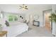 Bright main bedroom boasts vaulted ceilings, neutral colors, and a ceiling fan at 17020 E 107Th Ave, Commerce City, CO 80022