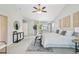 Airy main bedroom with ceiling fan, balcony access, and decorative fixtures at 17020 E 107Th Ave, Commerce City, CO 80022