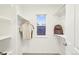 Bright walk-in closet featuring ample storage and a window at 17020 E 107Th Ave, Commerce City, CO 80022