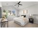 Inviting bedroom featuring a ceiling fan, carpet, and a view of the outdoors at 22580 E Ontario Dr # 204, Aurora, CO 80016