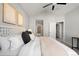 Comfortable bedroom featuring plush bedding, natural light, and access to additional rooms at 22580 E Ontario Dr # 204, Aurora, CO 80016