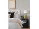 Elegant bedroom with bedside table lamp, and artistic decor for a restful atmosphere at 22580 E Ontario Dr # 204, Aurora, CO 80016