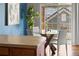 Bright dining area adjacent to the kitchen featuring a glass table, modern chairs, and sliding door access to a balcony at 22580 E Ontario Dr # 204, Aurora, CO 80016