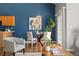Stylish dining area features modern furniture, hardwood floors, and bright blue accent wall, creating an inviting atmosphere at 22580 E Ontario Dr # 204, Aurora, CO 80016