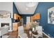 Open concept view of a dining area with a fireplace, adjacent to a kitchen with wood cabinets and stainless appliances at 22580 E Ontario Dr # 204, Aurora, CO 80016