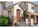 Inviting front entrance showcases stone accents, a well-manicured lawn and steps leading to the front door at 22580 E Ontario Dr # 204, Aurora, CO 80016