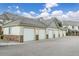 Attached garages with white doors on a building with siding and stone veneer accents at 22580 E Ontario Dr # 204, Aurora, CO 80016