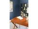 Stylish home office features built in shelving, modern desk, decor and neutral colored carpet at 22580 E Ontario Dr # 204, Aurora, CO 80016